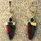dangle earrings with trillion-cut pyrope garnets and tongue-shaped jasper.