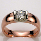 14 Karat Rose gold two-tone saddle ring with 0.63 carat round brilliant diamond in platinum saddle.