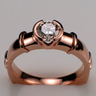 14 Karat Rose gold ring with 0.55 ct. round brilliant diamond in semi-bezel with decorative bars.