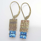 princess-cut natural blue zircon dangles with multi-colored textured 14 karat gold plates.