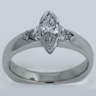Ploatinum diamond ring with a marquise-cut center stone and trilliant sides.