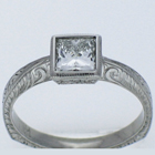 Hand-engraved Palladium diamond ring with princess-cut diamond in full engraved bezel on knife-edge style shank.