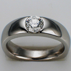 Platinum ring with flush-set round brilliant diamond.