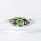 Platinum wrap-around v-shaped channel ring with channel-set iradiated green round brilliant diamond