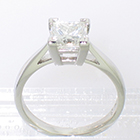 Platinum solitaire ring with princess-cut square diamond in 4-prong setting on cathedral shank