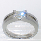 Platinum matte-finished solitaire with princess-cut diamond in angular saddle setting over open channel