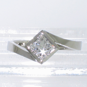 Platinum solitaire with princess-cut diamond in diagonally-oriented full bezel