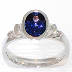 Platinum 5-stone ring with Oval Color-Changing Sapphire in full bezel, channel-set Crescent-moon-shaped white diamonds, and prong/channel-set Crescent-shield-shaped white diamonds