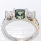 Platinum triple-saddle ring with square-cushion-shaped green Sapphire and princess-cut white diamonds channel-set into saddles