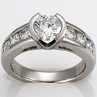 platinum ring with round brilliant diamond in semi bezel on tapered-channel shank.