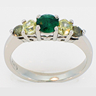 platinum ring with round emerald, two hexagonal-shaped yellow diamonds, and two round green diamonds - all natural, all set in prong-style settings.