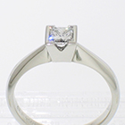 Platinum solitaire with princess-cut diamond in v-cut semi-bezel setting