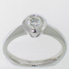 Palladium solitaire ring with round brilliant diamond in full bezel with angled rim