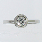 Palladium solitaire ring with round brilliant diamond in full bezel with angled rim (alternate view)