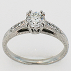 Platinum hand-engaved diamond ring with empire-style setting on gallery-style shank.