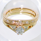 14 Karat Yellow gold split-shank hand-engraved wedding set with flush-set round melee diamonds in hand-engraved band