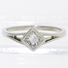 Platinum split-shank solitaire with diagonally-oriented bezel-set princess-cut diamond