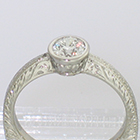 Platinum hand-engraved solitaire with 0.54 carat round brilliant diamond in full bezel (detail view)
