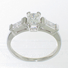 Platinum 3-stone ring with 0.81 carat radiant-cut diamond set in 4-prong gallery head and 0.42 carat total weight brilliant-cut baguettes channel-set between gallery bars