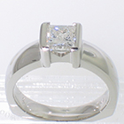 Platinum solitaire with 1.01 carat princess-cut diamond in "bracket-style" semi-bezel on polished heavy shank