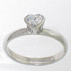 Platinum solitaire with heart-shaped diamond in full bezel