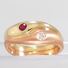 14 Karat 2-tone Yellow and Rose Gold ying-yang ring with flush-set round Ruby and Diamond