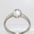 Palladium solitaire ring with oval-shaped caboschon-cut moonstone in full-bezel setting
