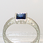 Palladium hand-engraved solitaire ring with princess-cut Sapphire in full bezel setting