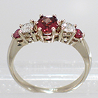 14 Karat White Gold 5-stone ring with oval-shaped Pink Sapphire, round white diamonds, and round pink Sapphires in gallery-style prong settings