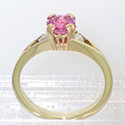 14 Karat Yellow Gold 3-stone ring with round Pink Sapphire in fancy "empire-style" 8-prong setting and round white diamonds channel-set into split shank