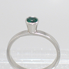 Platinum "stacker" solitaire with round Emerald in high-profile full bezel setting on flat band