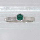 Platinum "stacker" solitaire with round Emerald in high-profile full bezel setting on flat band (alternate view)