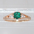 14 Karat Rose Gold 3-stone ring with round Emerald in 6-prong "gallery" style setting with round white diamonds channel-set into split-shank (alternate view)