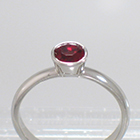 Platinum Solitaire with round Ruby in full bezel setting