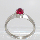 Palladium solitaire ring with cushion-shaped bullet-caboschon-cut Ruby in full bezel setting