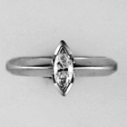 platinum knife-edge style band with marquis-cut diamond solitaire