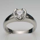 platinum ring with 1.09 carat round diamond in split-bezel setting on thick rounded shank.