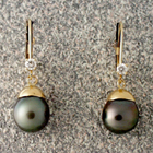 dangle earrings with black pearls and diamonds in 14 karat yellow gold.