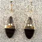 dangle earrings with bullet-shaped rutilated quartz and tongue-shaped black onyx.