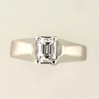 platinum ring with emerald-cut diamond in 4-prong setting on angular shank