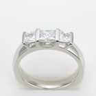 Platinum three-stone ring with princess-cut diamonds in sideways channels
