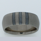 14 karat white gold comfort-fit band with 3 iron horseshoe nail inlays. Brushed finish.