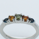 Platinum diamond ring with natural green center diamond and natural orange diamonds and natural color-changing Alexanderites.
