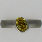 Brushed Platinum band with oval-shaped natural fancy intense canary-yellow diamond in diagonally-oriented half-bezel.