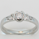 Palladium diamond ring with round brilliant, crescent moons, and crescent trilliants.