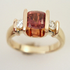 rose gold saddle set round orange sapphire with round side diamonds