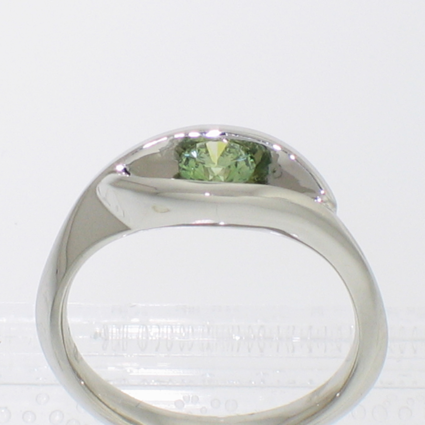 Platinum wrap-around v-shaped channel ring with channel-set iradiated green round brilliant diamond (alternate view)