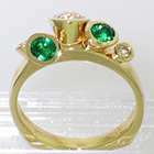 14 Karat Yellow Gold multi-bezels ring with Emeralds and Diamonds set all "willy-nilly" in conical bezels