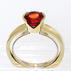 14 Karat Yellow Gold solitaire with orange Sapphire in semi-bezel