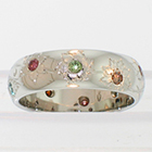 Platinum hand-engraved band with flush-set irradiated colored diamonds